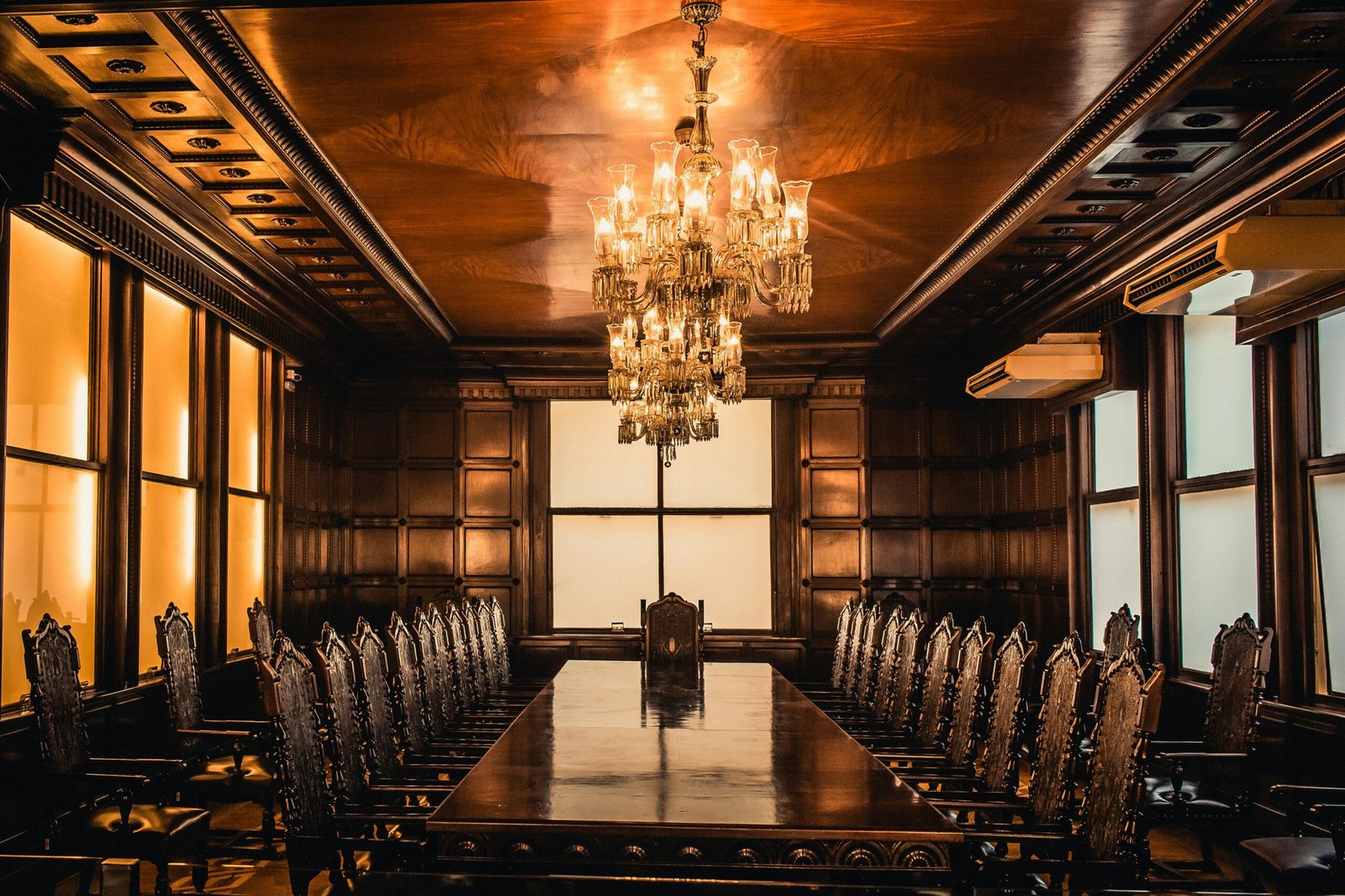 Elegant boardroom with a grand chandelier, showcasing a well-maintained, clean environment by Modern Cleanings in Austin, TX.